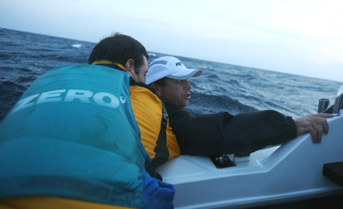 Marc helps Simon - end of 24hr surfski record attempt